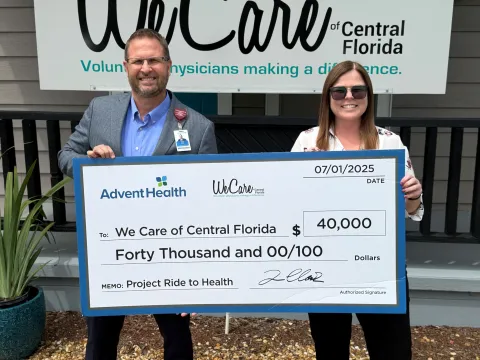 Photo of AdventHealth Polk Market President and CEO Tim Clark and We Care of Central Florida CEO Heather Stephenson with check presented by AdventHealth Heart of Florida