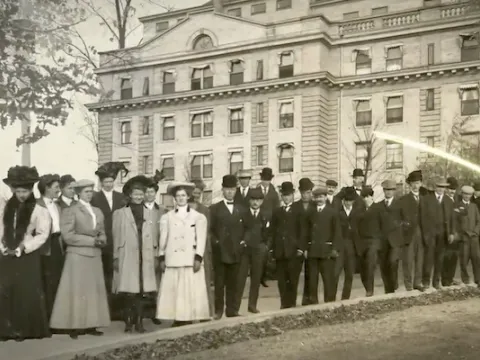 Black and white historical photo of people standing in front of a Sanitarium
