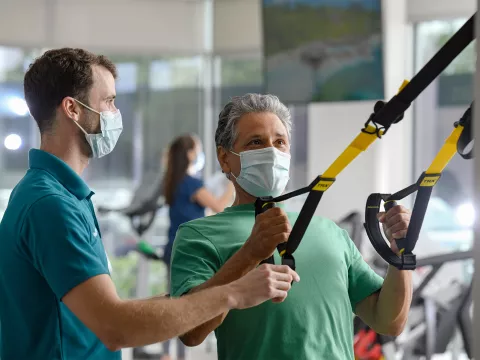 Man with trainer at the AdventHealth Health Park gym.