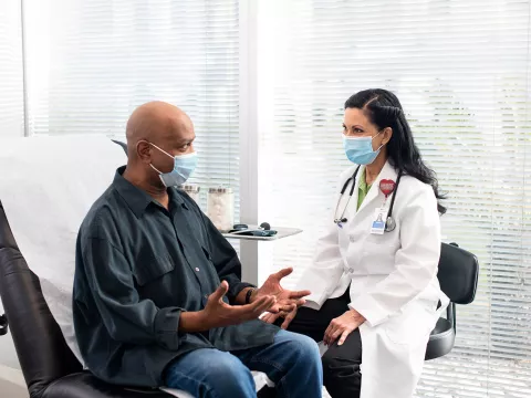 An AdventHealth doctor talking with a patient of color