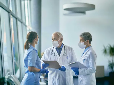 Two doctors and a nurse having a discussion