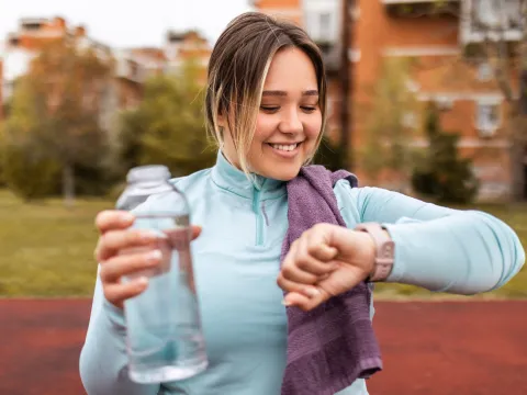 Woman Checking her time after a run