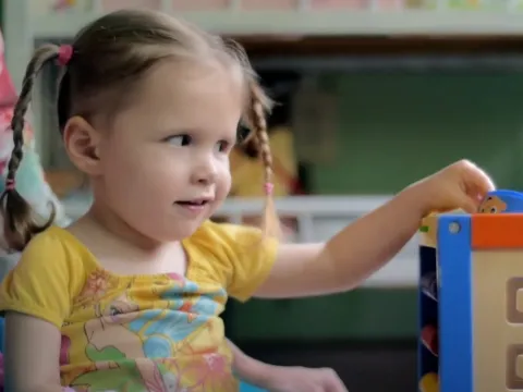 Joscelyn playing with her toys