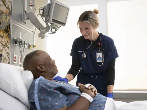 Nurse smiling at patient.