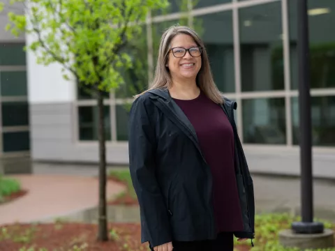 Woman stands in front of breast center