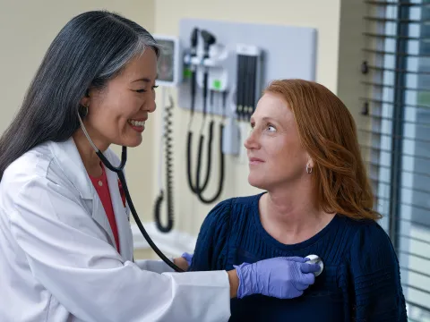 Doctor checking heart beat.