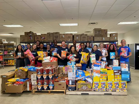 Texas Health Hospital Mansfield team and Mansfield Mission Center pose with 33,746 servings of cereal.