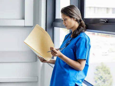 A doctor reads the results of a study.