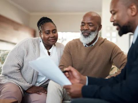 Couple talking with a specialist about insurance.