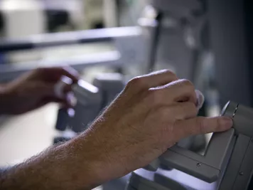 A person's hands holding equipment