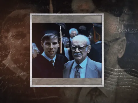 David Banks wearing a cap and a gown stands beside his grandfather on the day of his college graduation ceremony.