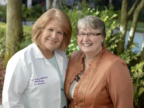Deb Beck and Deenie Cochran smiling for a photo outdoors.