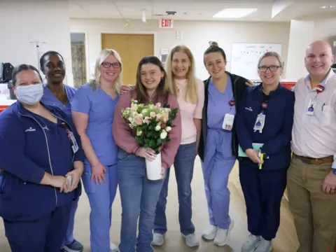 Patient surrounded by the AdventHealth staff