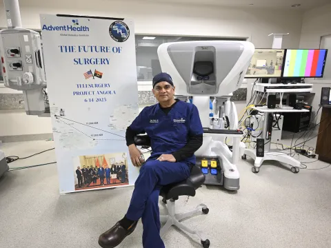 Dr. Vip Patel with Angola surgery banner