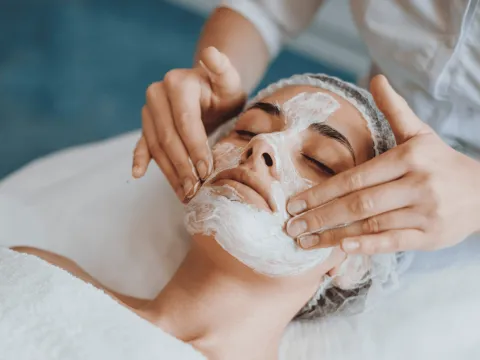A woman receiving a facial.