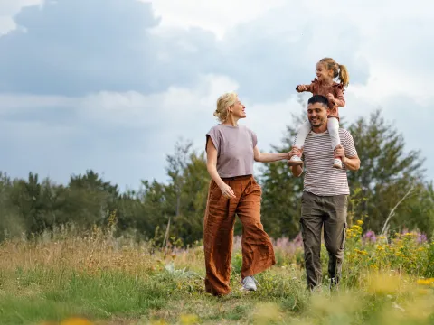 Family walking together in a meadow