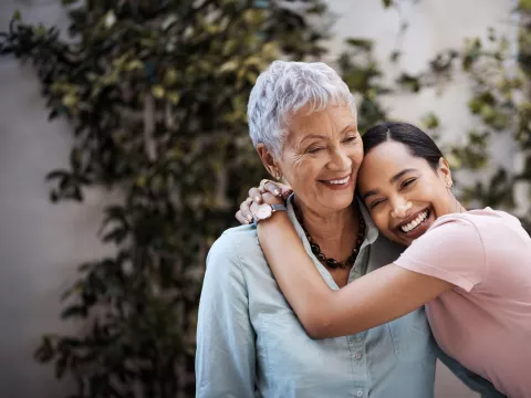M teenage girl hugs her grandmother