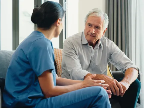 Nurse talking with older male patient