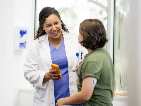 Physician talking with young diabetes patient