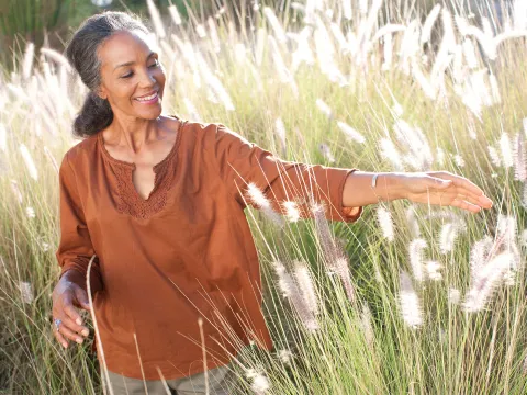 A woman outdoors in a field. 