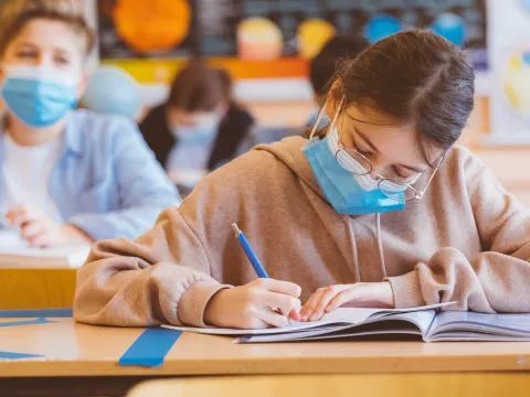 Children wearing masks in the classroom.
