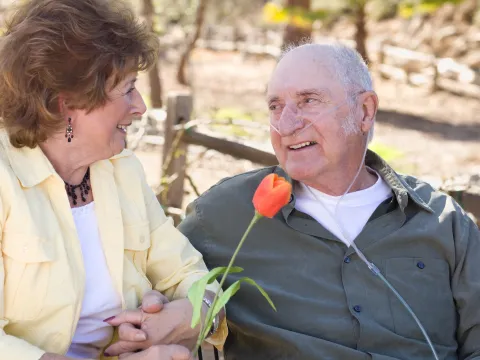 A couple sits outdoors together.