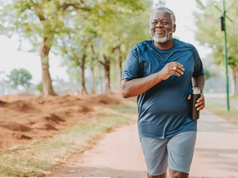 Middle aged man running in the park