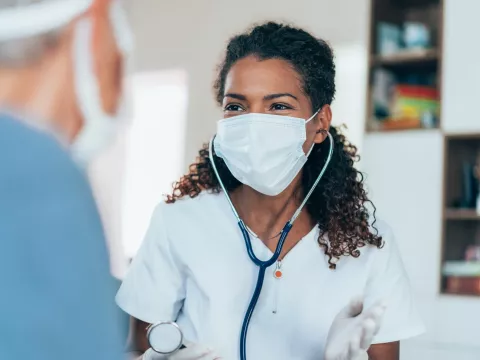 A doctor talking to a patient during an office visit.