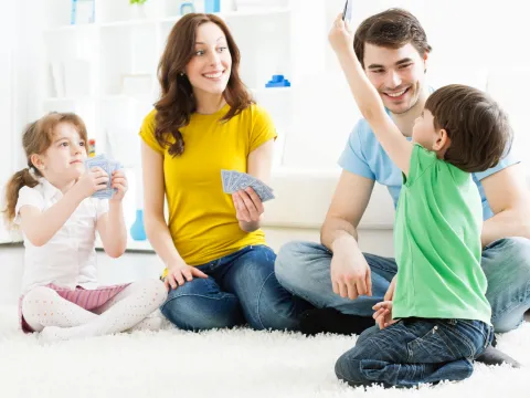 A family plays a game of cards together.