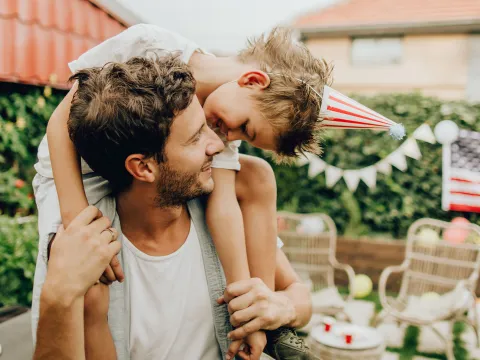 A father and son celebrate Independence Day at home.