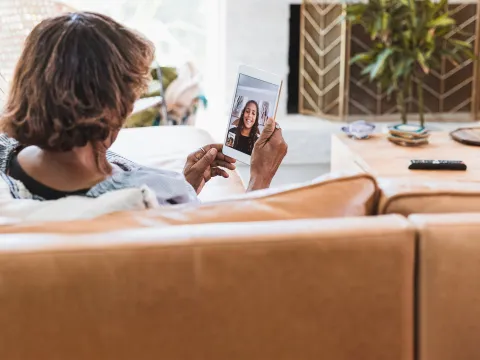 A grandmother talking to her granddaughter virtually