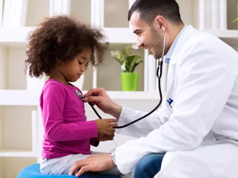 A little girl gets a check up at her doctor's office.