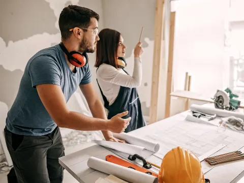 A young couple renovating a home. 