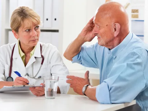 A man discusses his symptoms with his doctor.