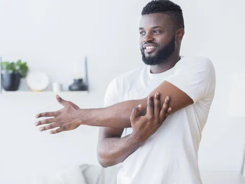 A man stretching at home.