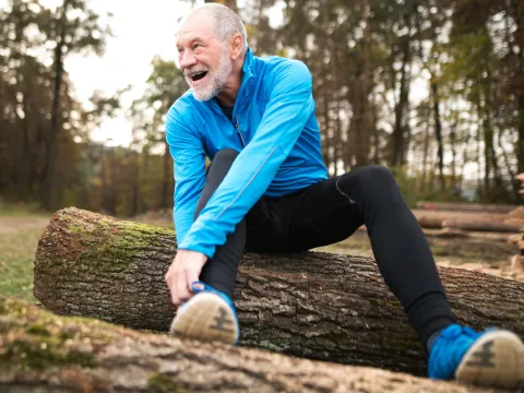 A man stretches outdoors.