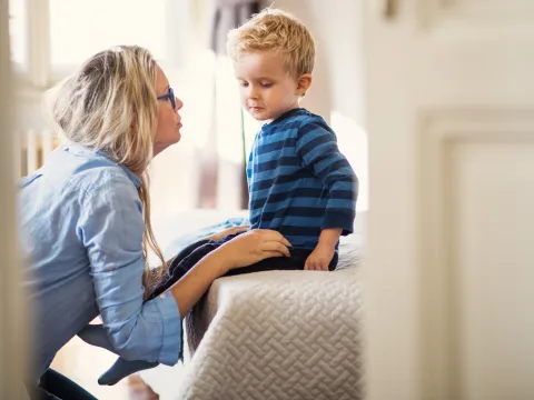 A mother comforts her young son.