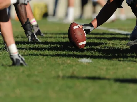 Football players practicing on a field.