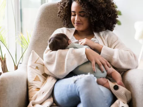 A new mom holding her infant. 