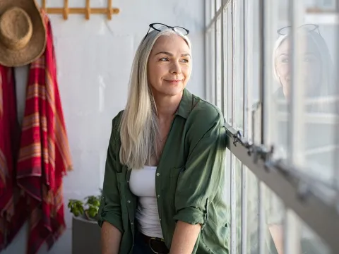 A woman sitting by the window. 