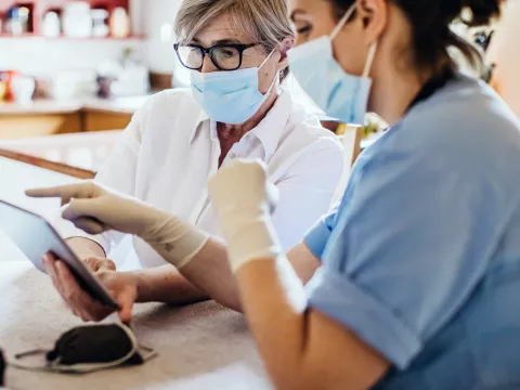 A woman reviews her test results with her provider safely. 