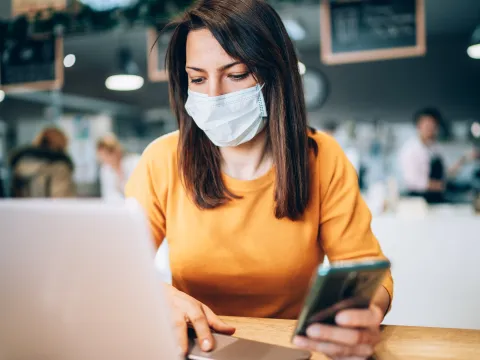 A woman social distancing in public. 