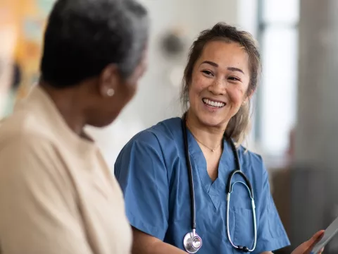 A woman talks with her doctor about her test results.