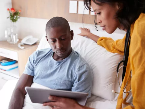 Young man discusses his care with a provider