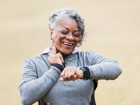 Female runner checking her wearable device