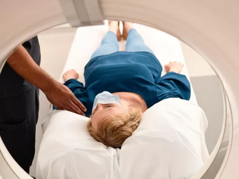 Woman wearing a mask getting an MRI