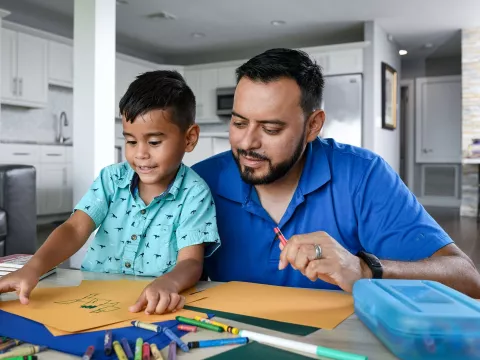 Man coloring with his son