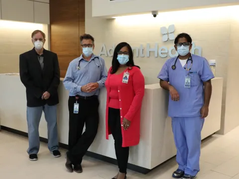 Clinicians posed in front of front desk