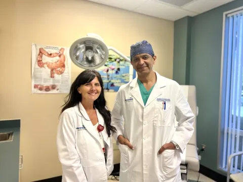 General Surgeon Dr. Abubaker Ali and APP Tina Ellison smiling for a photo.