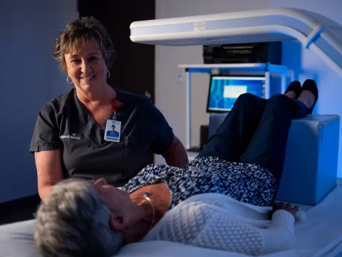 Senior female patient receiving a bone density scan.